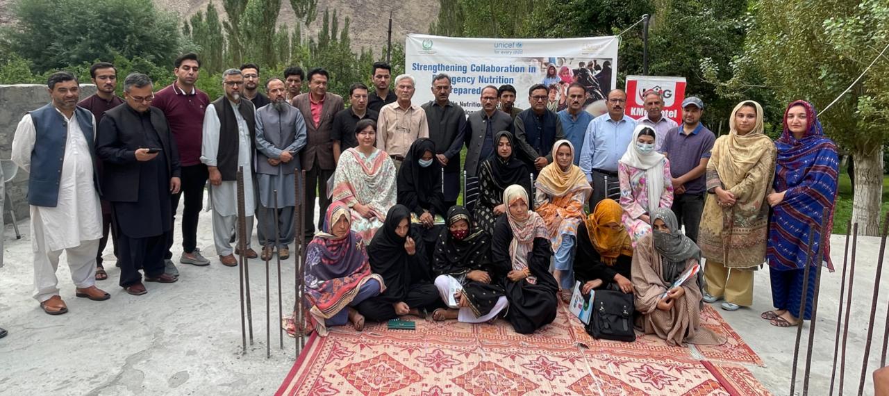 Participants pose for group photo after conclusion of one day workshop on food emergency and malnutrition in Skardu